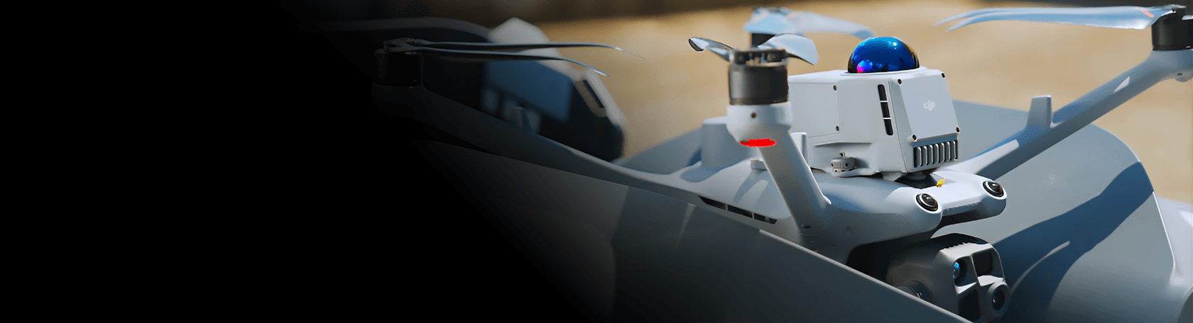 En avancerad drönare med flera propellrar och en kamera är redo för flygning på en utomhusplats.