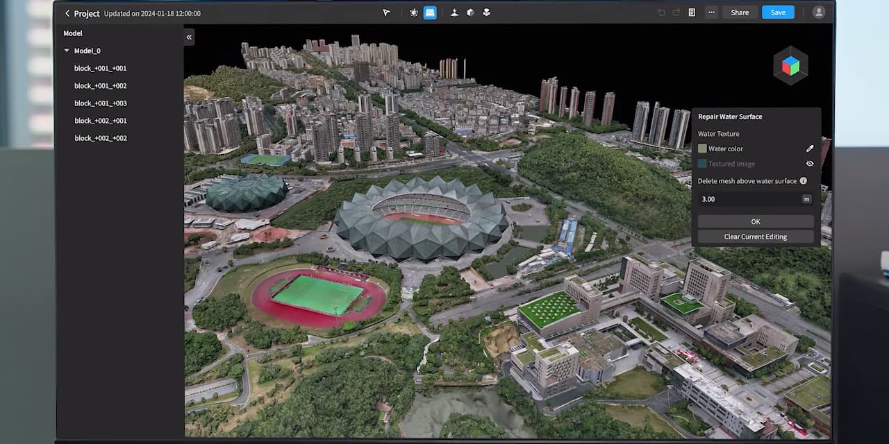 En detaljerad 3D-modell av en stadsmiljö visas på en datorskärm, med fokus på ett stadion och omgivande byggnader och grönområden.