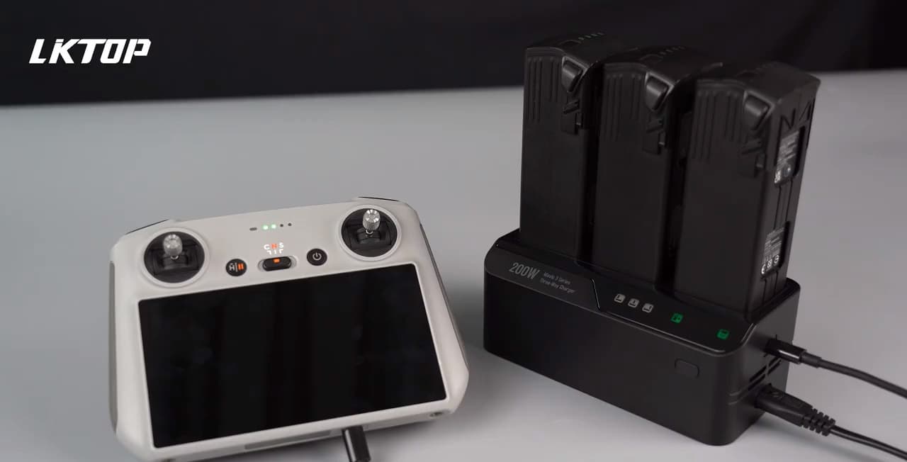 En fjärrkontroll och en laddningsstation med flera batterier visas på ett bord, med texten 'Multi-device charging compatible'.